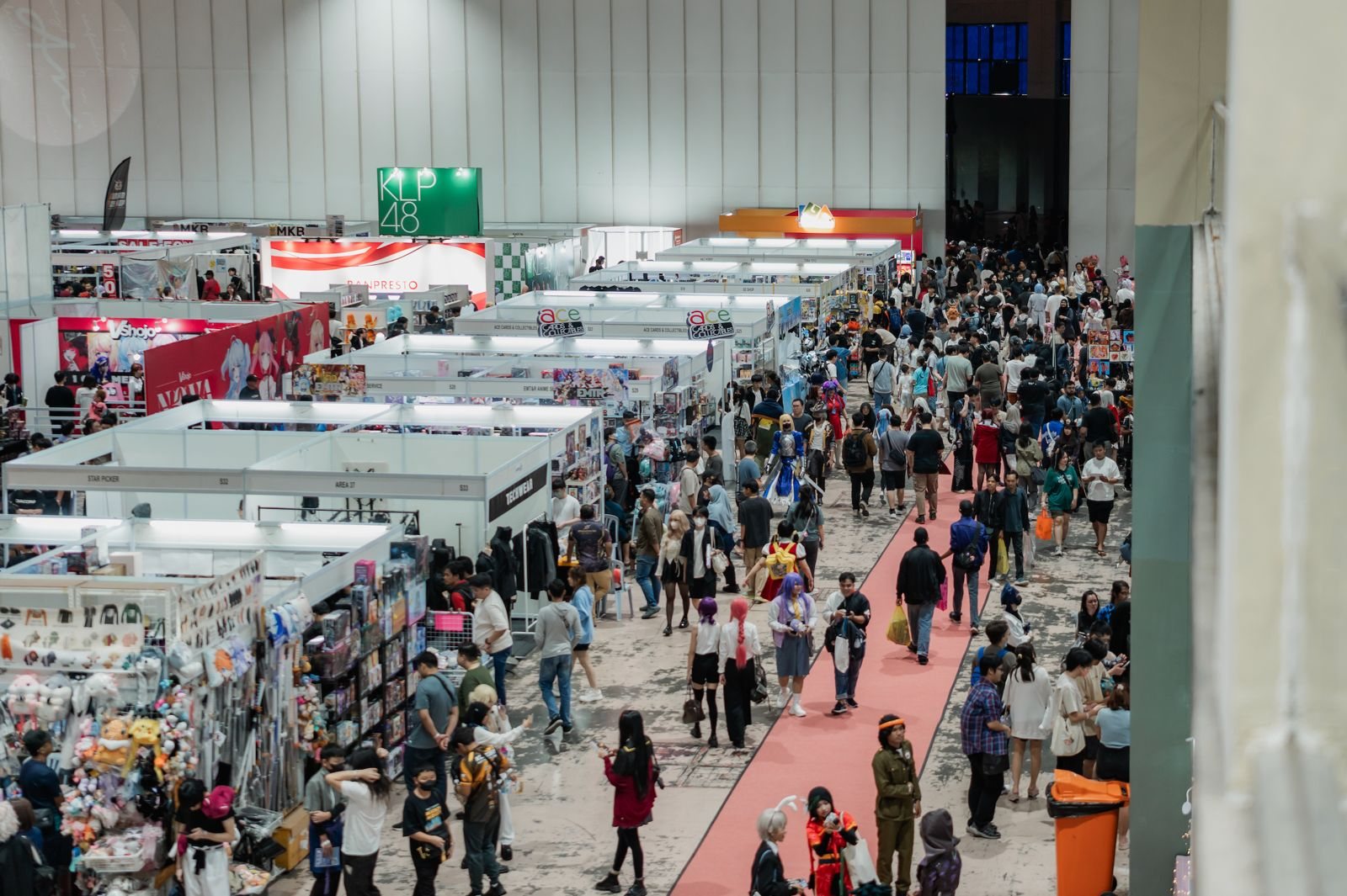 Wide exhibition hall with many attendees